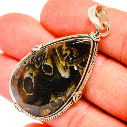 Teardrop agate pendant with silver rope-edge bezel and bail, amber-black pattern