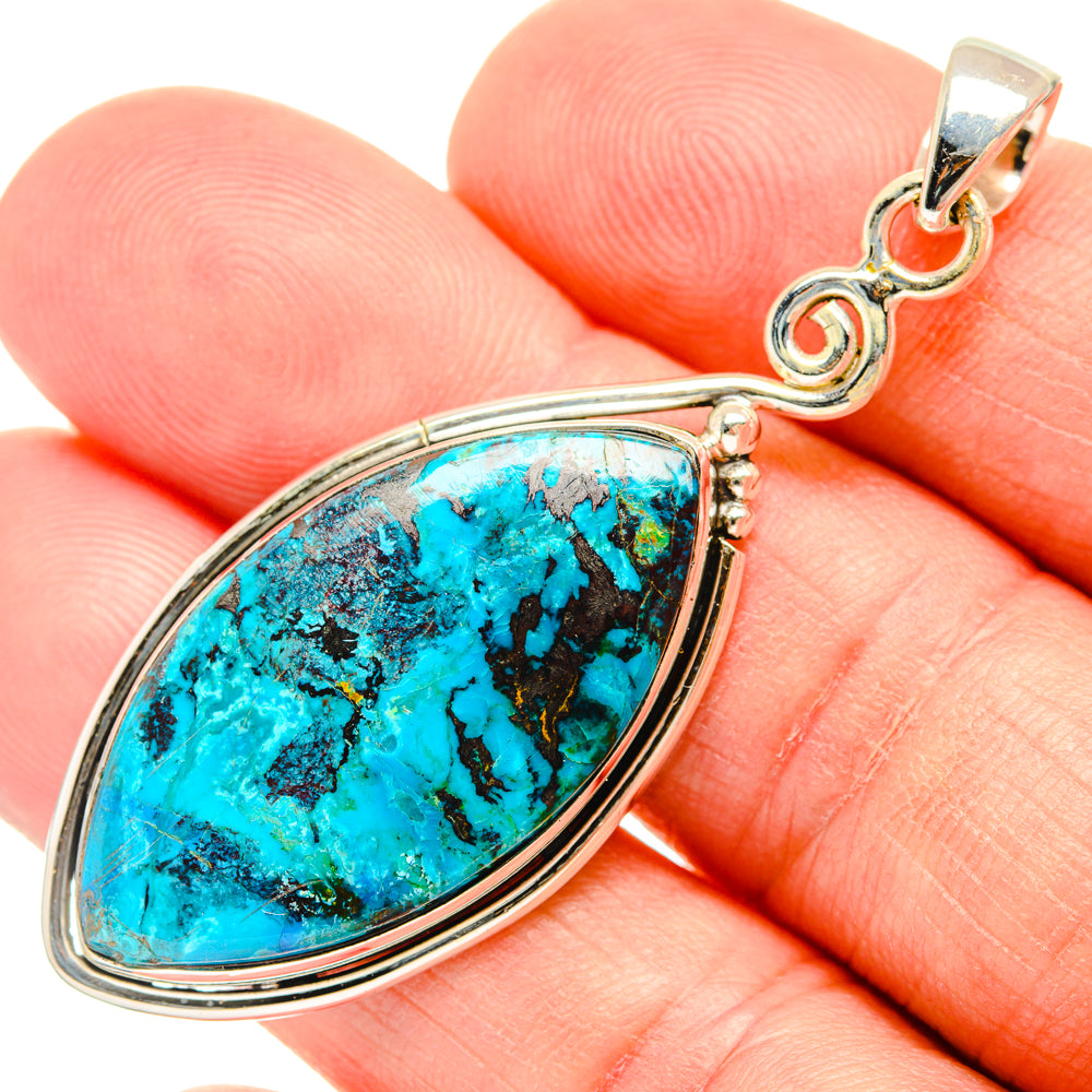 Turquoise teardrop stone pendant in sterling silver with ornate bail, close-up
