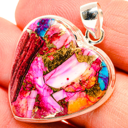 Heart-shaped multicolor gemstone pendant close-up with silver bail; pink, red, blue, gold