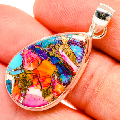 Teardrop gemstone pendant close-up, multicolor turquoise, pink, gold, and blue in silver bezel