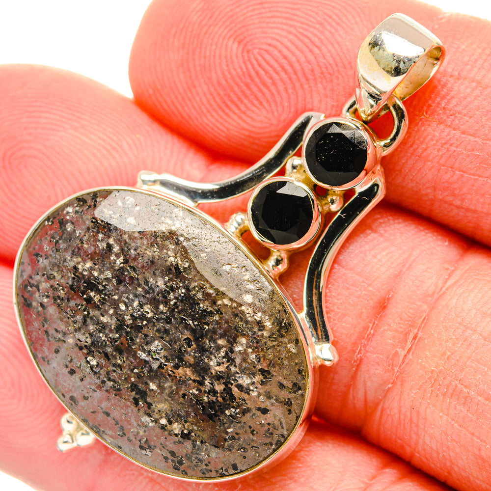 Tourmalinated quartz and black onyx pendant in silver-tone bezel, close-up view