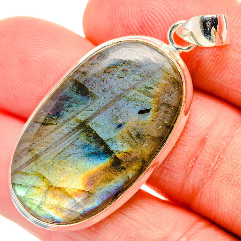 Oval labradorite pendant close-up in sterling silver setting, blue and gold iridescence