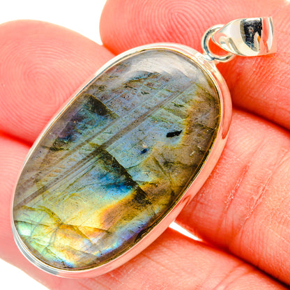 Oval labradorite pendant close-up in sterling silver setting, blue and gold iridescence