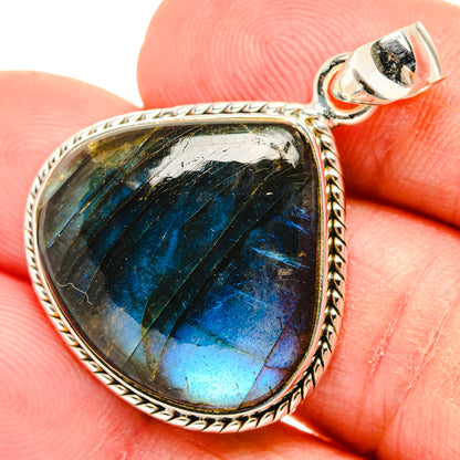 Oval labradorite pendant with twisted rope silver frame and blue iridescent center, bail loop
