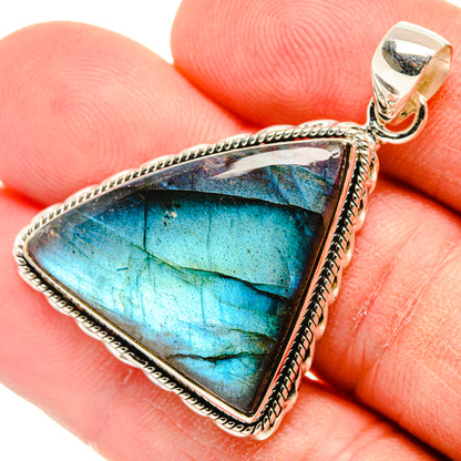 Triangular labradorite pendant in 925 sterling silver with blue cabochon and rope border.