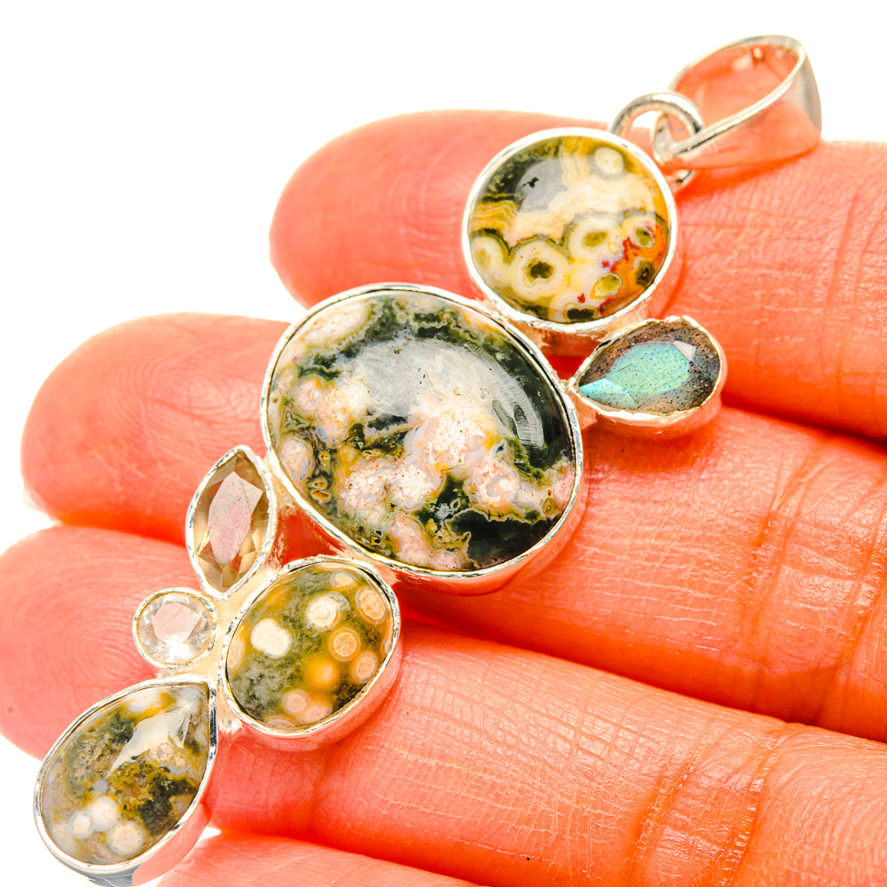 Sterling silver gemstone pendant with oval green, white, and yellow cabochons