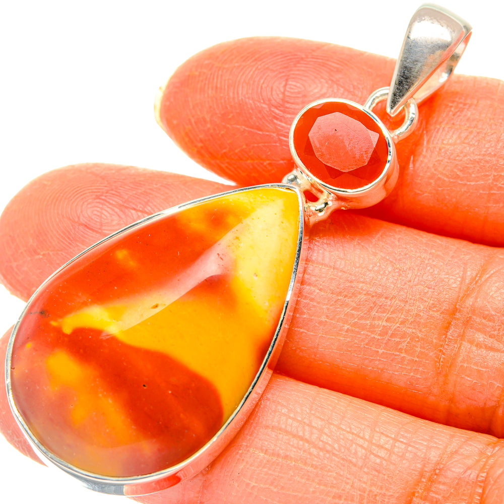 Close-up sterling silver pendant with orange and yellow pear-shaped carnelian stone