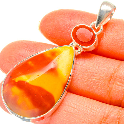 Close-up sterling silver pendant with orange and yellow pear-shaped carnelian stone