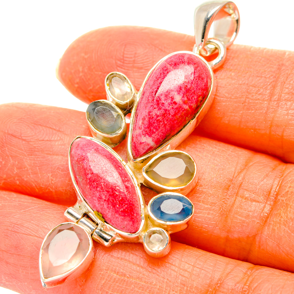 Gemstone pendant with red and pink oval cabochons in gold-tone bezels; silver bail