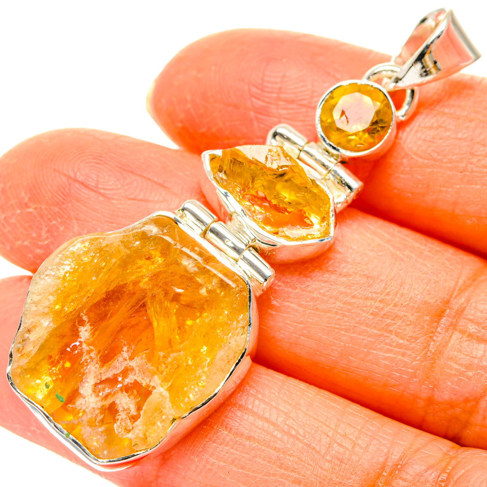 Rough citrine pendant with three silver bezel settings and top bail loop, close-up