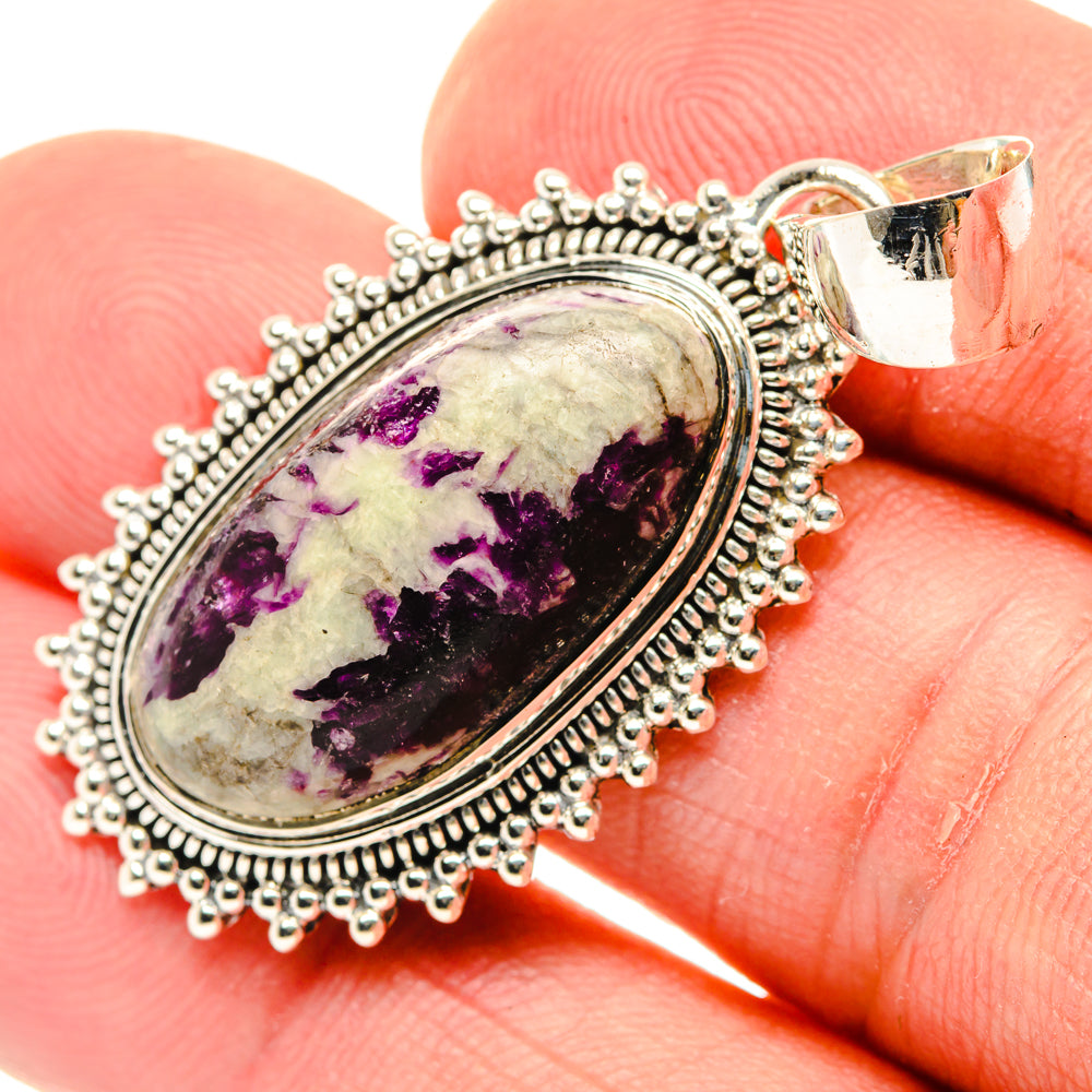Sterling silver oval pendant with bezel-set purple and black stone cabochon