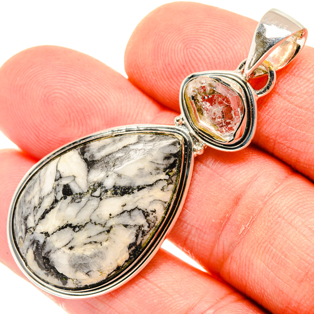 Sterling silver pendant with marbled white/black drop stone and red-toned crystal bezel