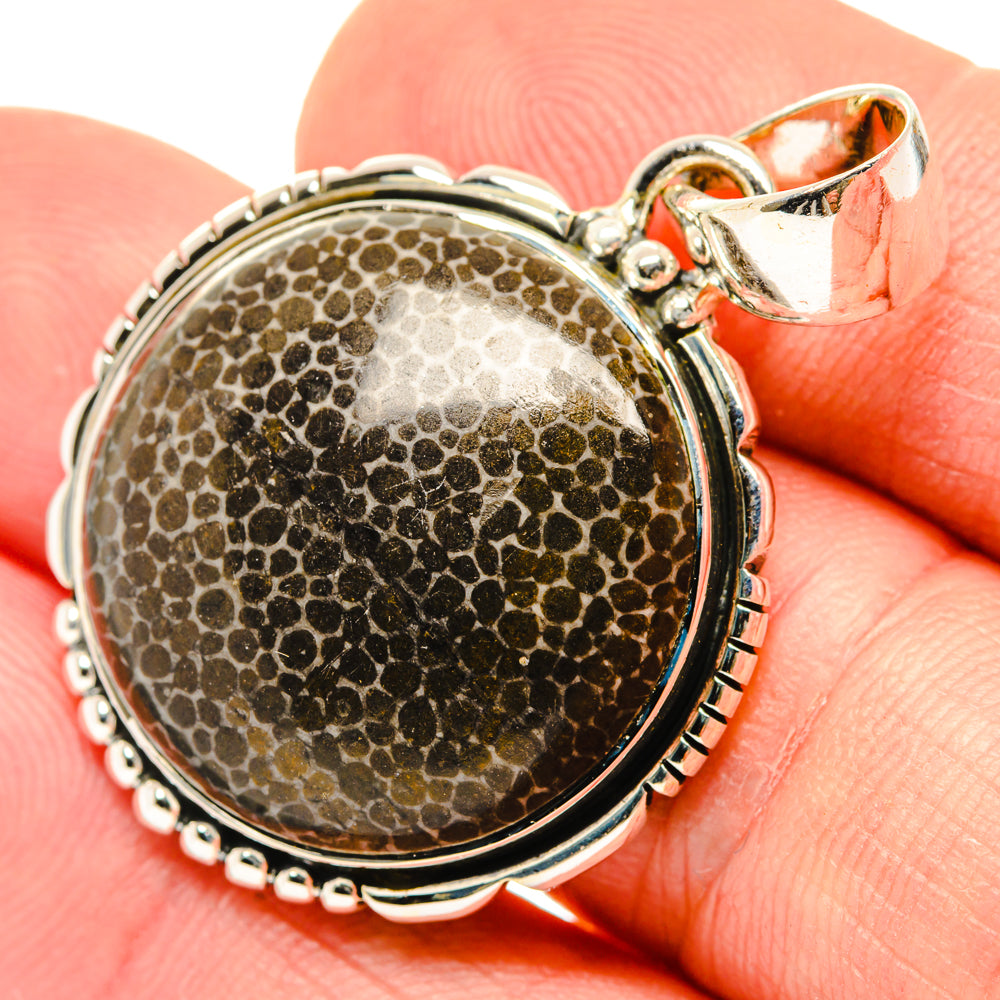 Round sterling silver pendant with stingray-coral cabochon and top bail