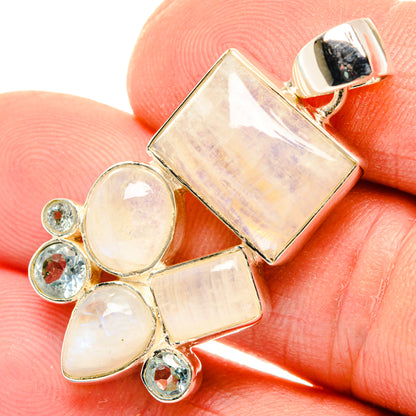 Sterling silver moonstone pendant with rectangular bezel and round blue topaz accents