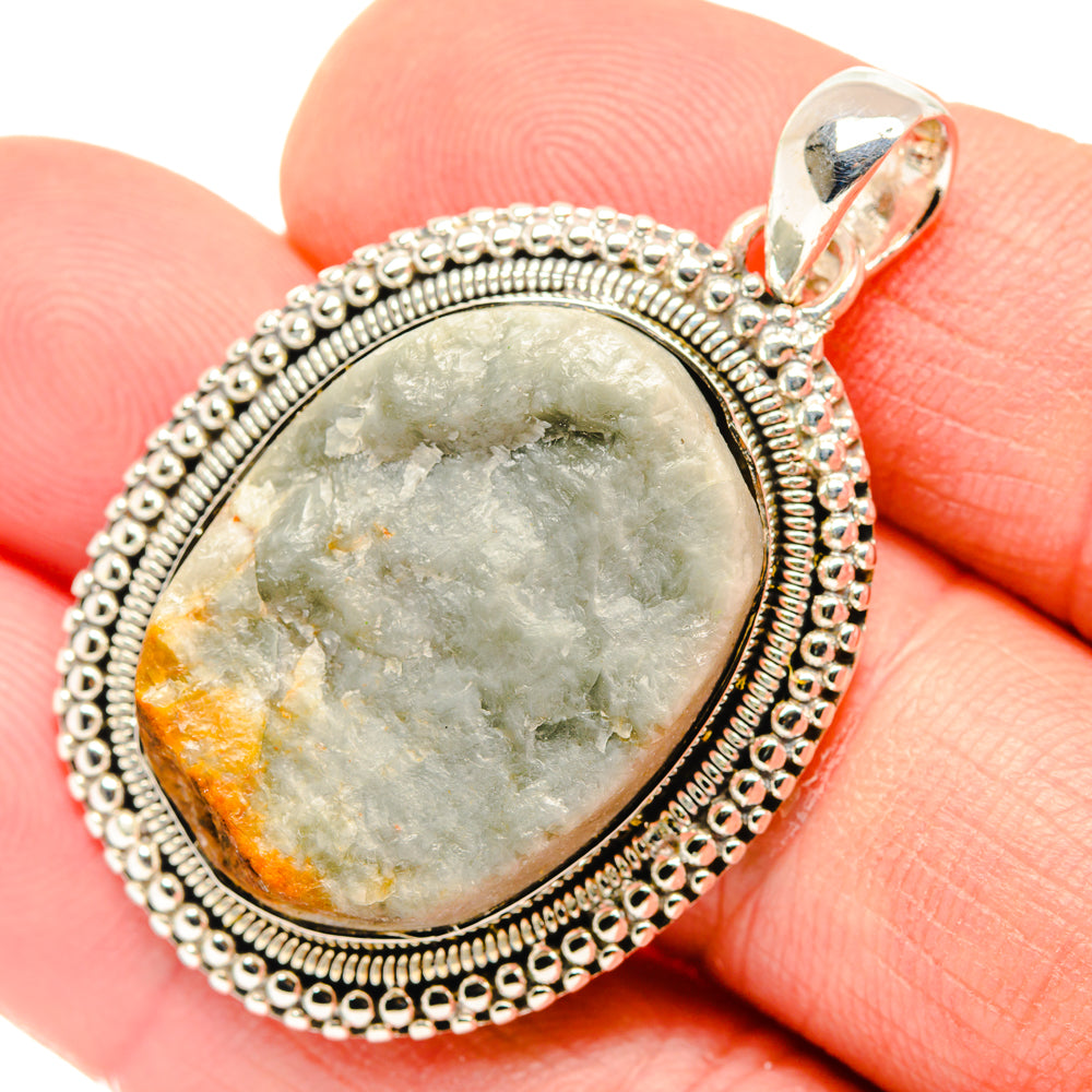 Sterling silver oval pendant with green quartz stone and textured bead frame