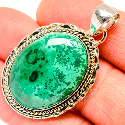 Oval green stone pendant with sterling silver rope edge and top bail detail.