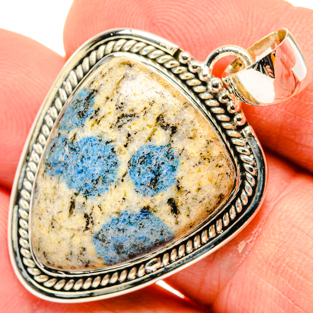Sterling silver teardrop pendant with blue azurite cabochon, ornate rope bezel