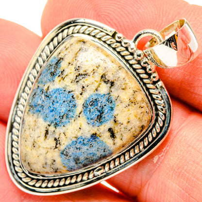 Sterling silver teardrop pendant with blue azurite cabochon, ornate rope bezel