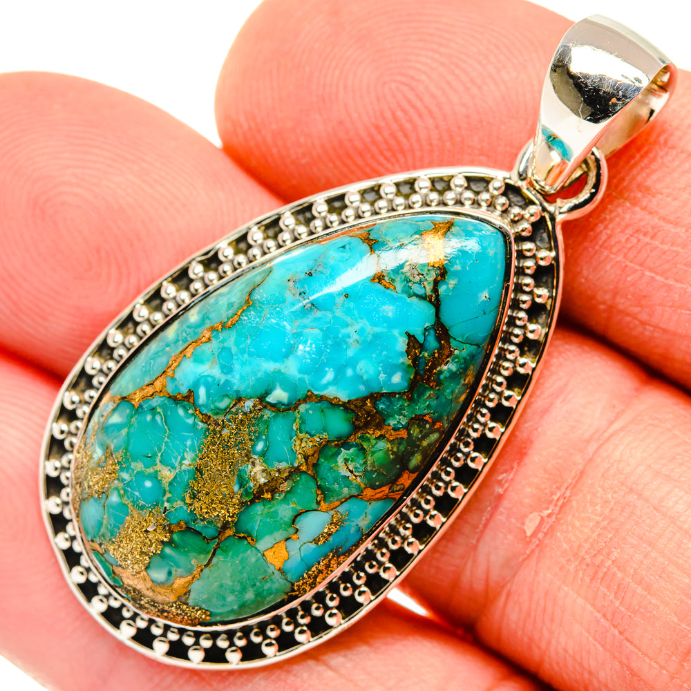 Oval turquoise composite pendant with ornate beaded sterling silver frame and bail