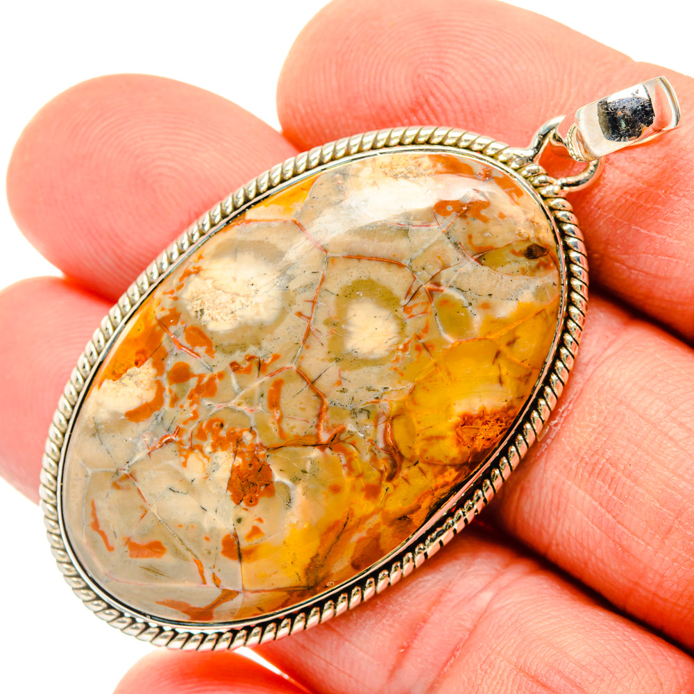 Sterling silver teardrop jasper pendant with textured bezel, yellow-orange stone