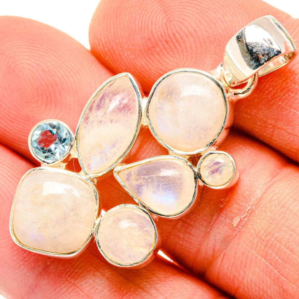 Sterling silver pendant cluster with opal-like ovals and blue topaz round on side