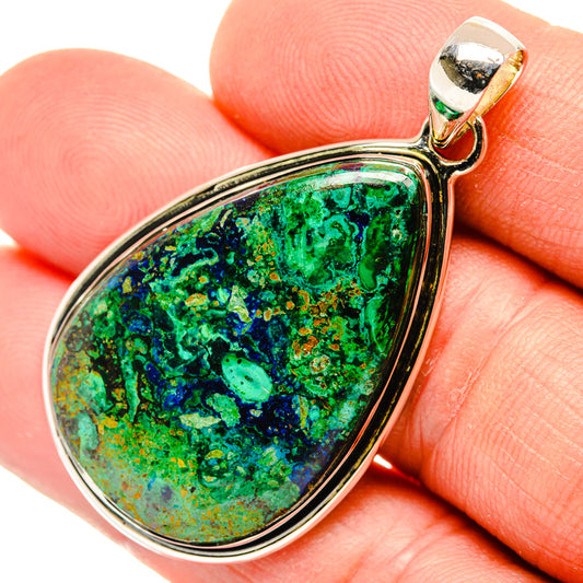 Close-up teardrop green-blue gemstone pendant in silver setting, 925 sterling