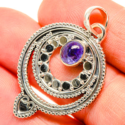 Sterling silver tanzanite pendant with round purple gemstone and textured circular frame
