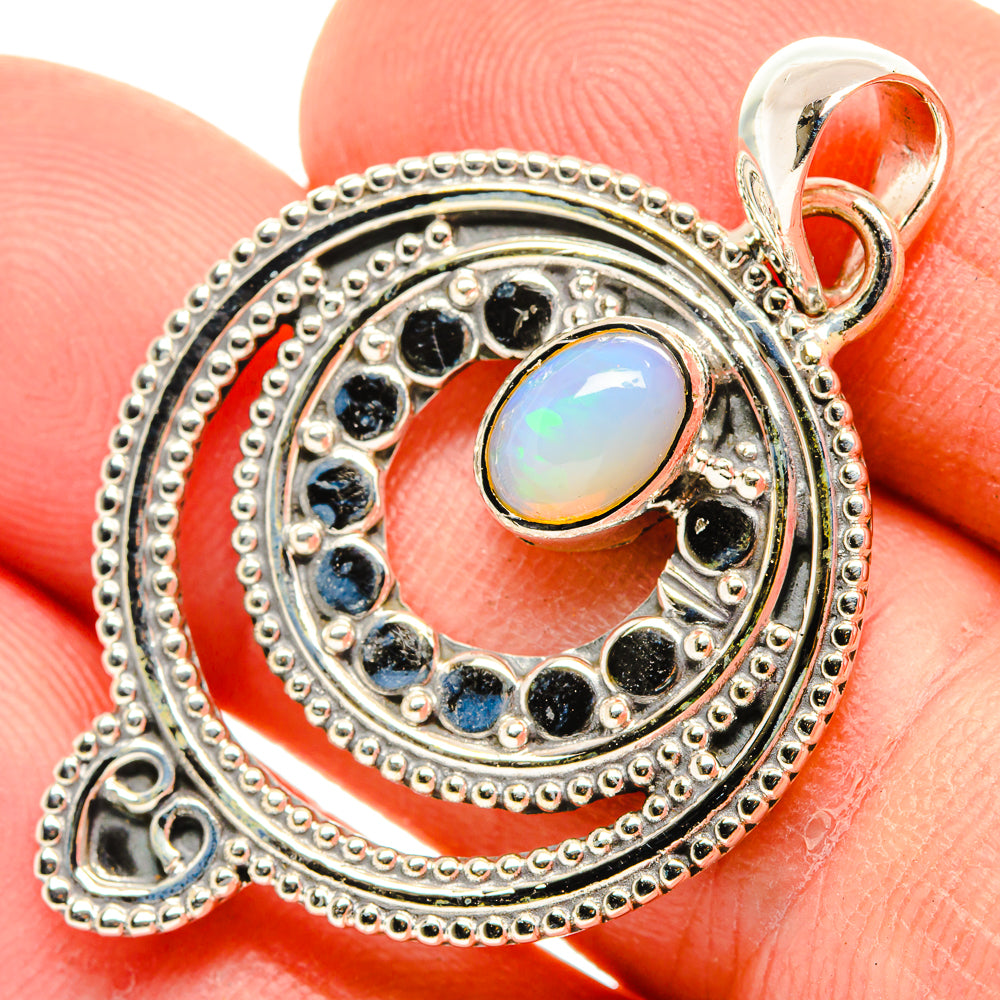 Sterling silver opal pendant with oval Ethiopian opal center and blue stone halo border