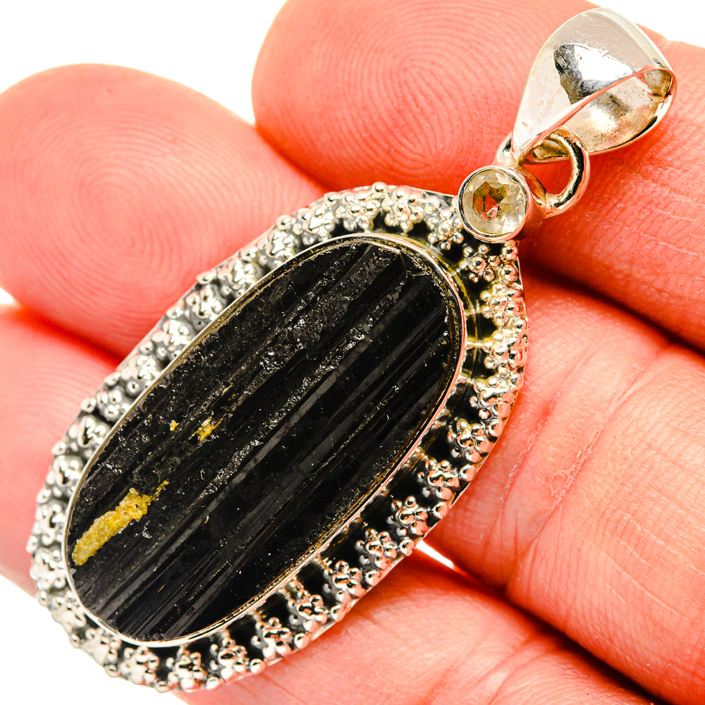 Tektite pendant: oval black tektite with yellow flecks, silver halo with round stones