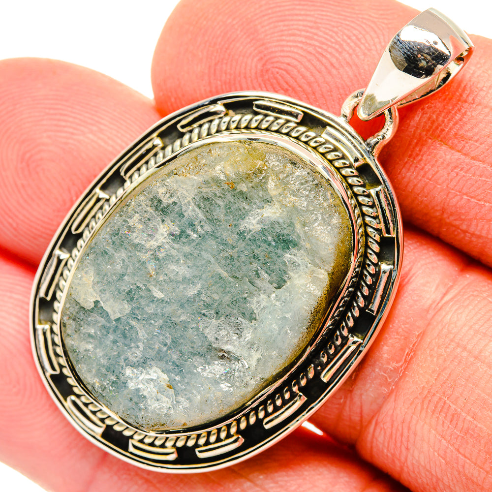 Sterling silver rough aquamarine oval pendant close-up with bail and bezel