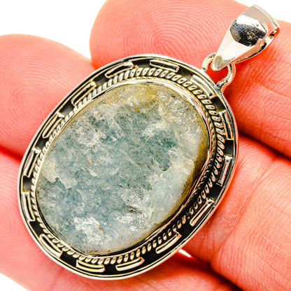 Sterling silver rough aquamarine oval pendant close-up with bail and bezel