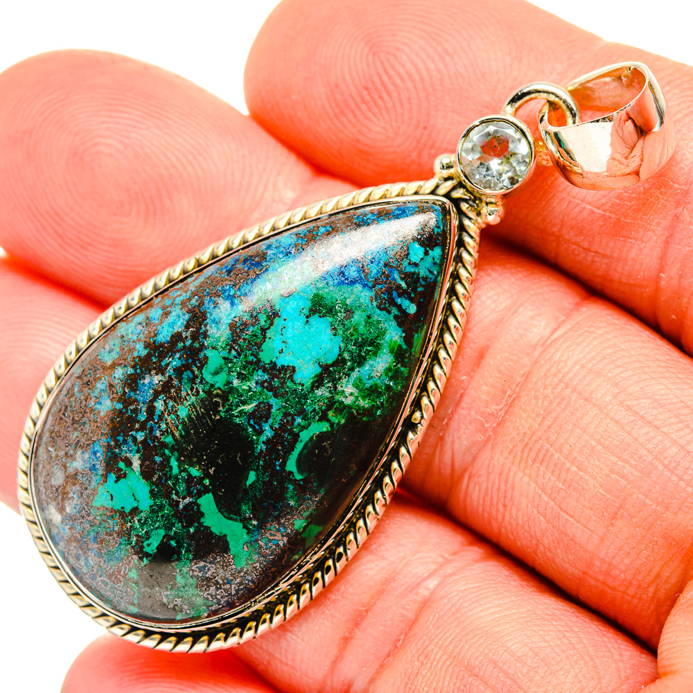 Close-up teardrop gemstone pendant in silver with blue-green stone and round top stone