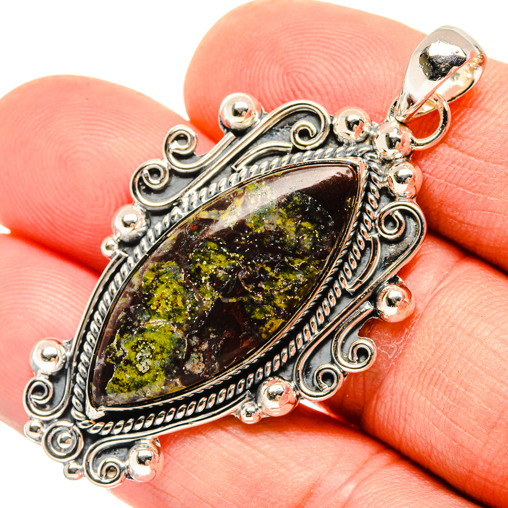Sterling silver oval pendant close-up, dark green and yellow marbled cabochon with bail