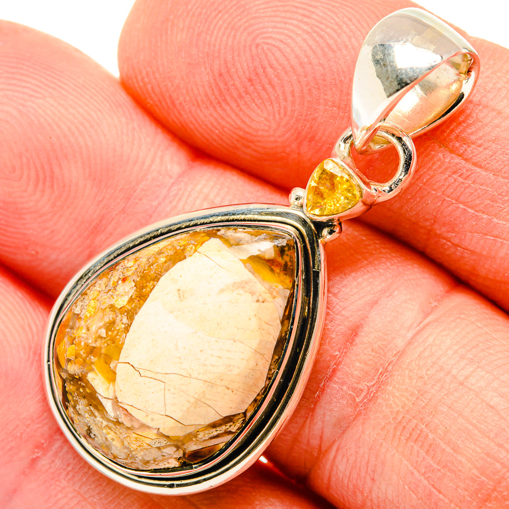 Close-up sterling silver pendant showing mookaite oval stone and round citrine