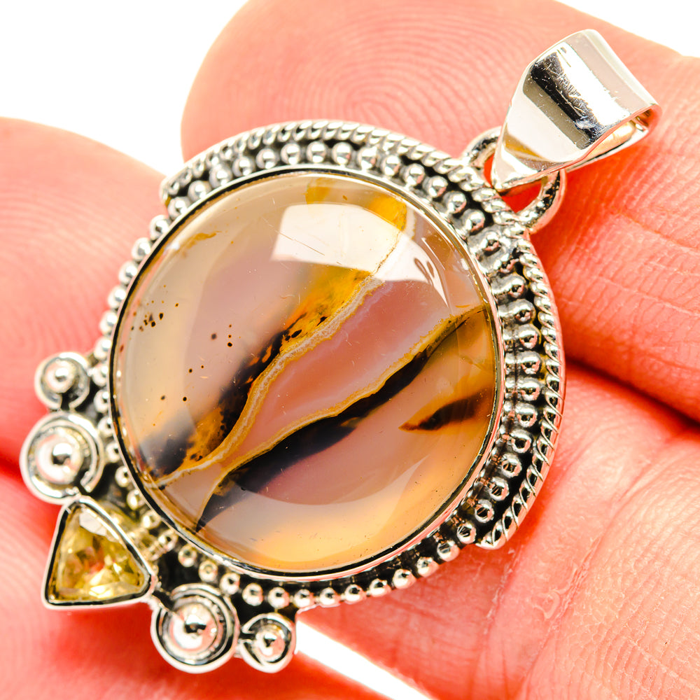 Close-up oval amber agate pendant with beaded 925 silver bezel and citrine charms