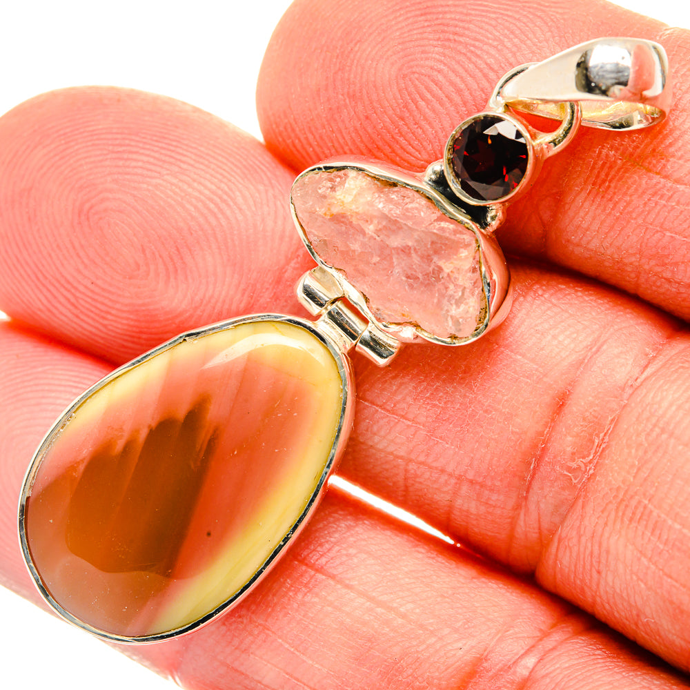 Sterling silver pendant with large oval yellow-orange gemstone, pink and dark red accents