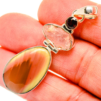 Sterling silver pendant with large oval yellow-orange gemstone, pink and dark red accents