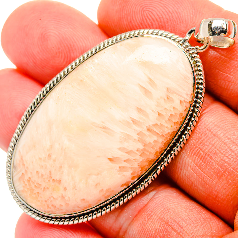Teardrop scolecite pendant in sterling silver with peach stone and raised border