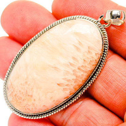 Teardrop scolecite pendant in sterling silver with peach stone and raised border