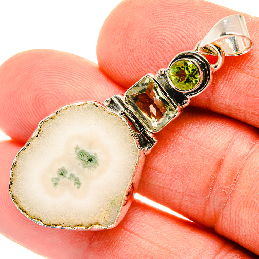 Heart-shaped white quartz pendant in 925 sterling silver with round green and amber stones
