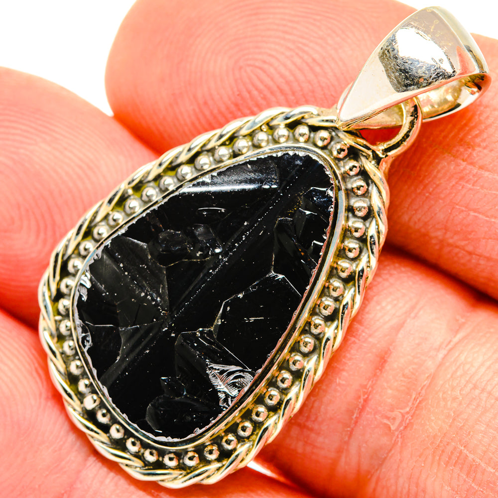 Teardrop black shungite pendant in textured gold-tone frame with top loop bail