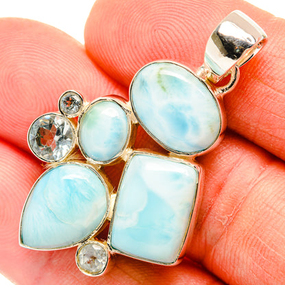 Oval blue gemstone pendant with sterling silver setting and round crystal accents