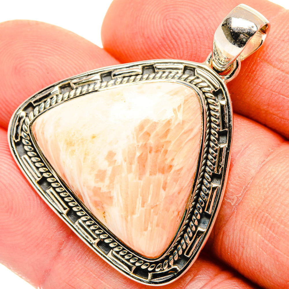 Sterling silver triangular scolecite pendant with ornate bezel and peach gemstone, bail loop
