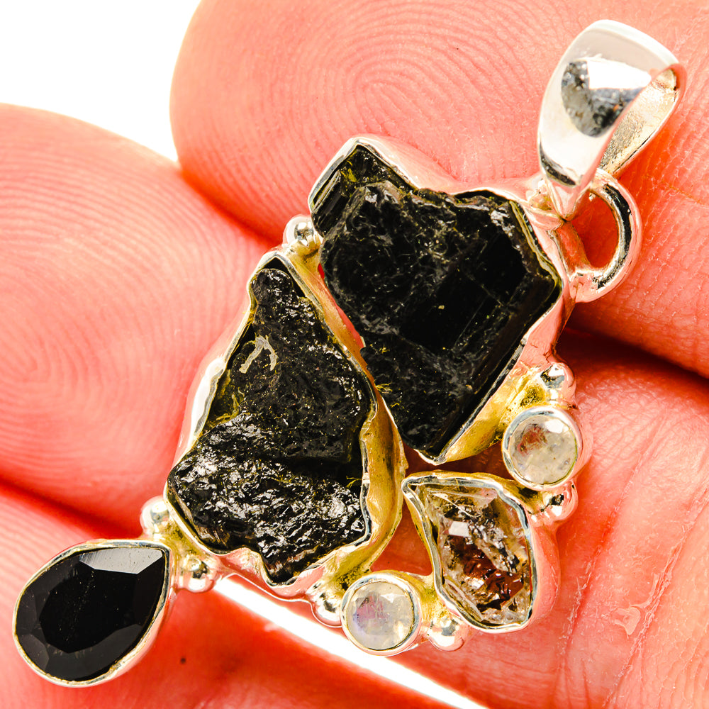 Sterling silver pendant with rough black tourmaline, round clear stones, openwork setting