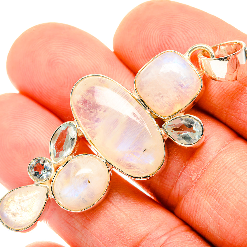 Opalescent heart pendant with small blue accent stones in a linked setting
