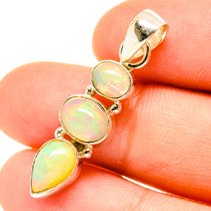 925 sterling silver opal pendant with three cabochon stones: round, round, pear