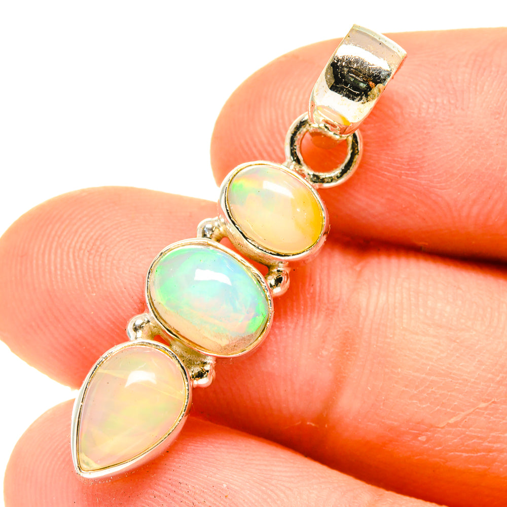 Sterling silver opal pendant with iridescent oval and teardrop opal stones, gold-tone bail