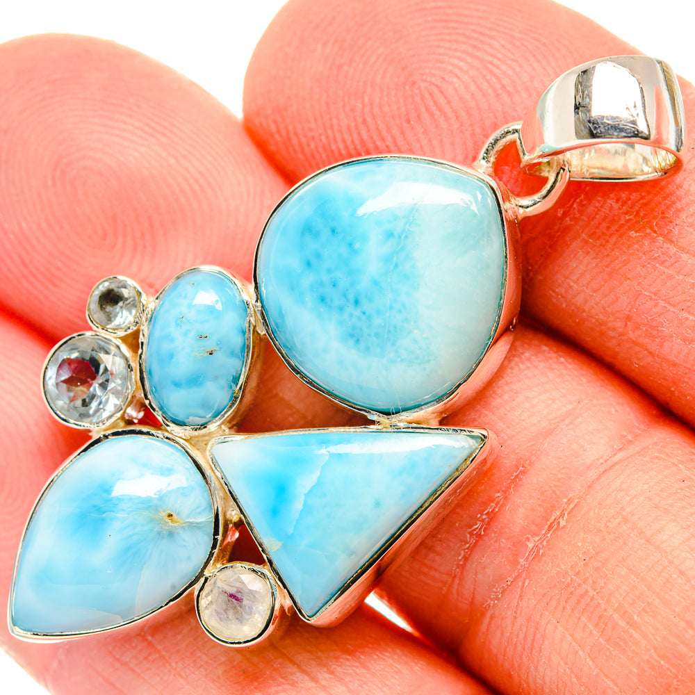 Blue stone pendant close-up, oval center and triangular drops with gold-tone bail