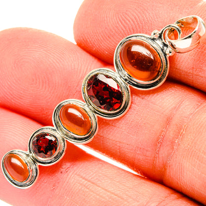 Sterling silver multi-stone pendant with orange and red round gemstones in bezels