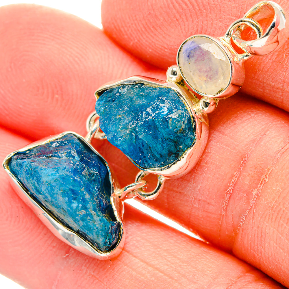 Sterling silver rough stone pendant with two blue pieces and a round moonstone